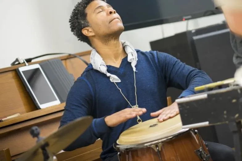 David Sánchez headshot playing the bongos