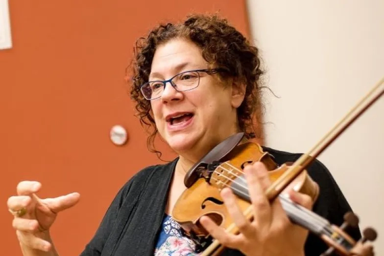 Kay Stern teaching while holding violin