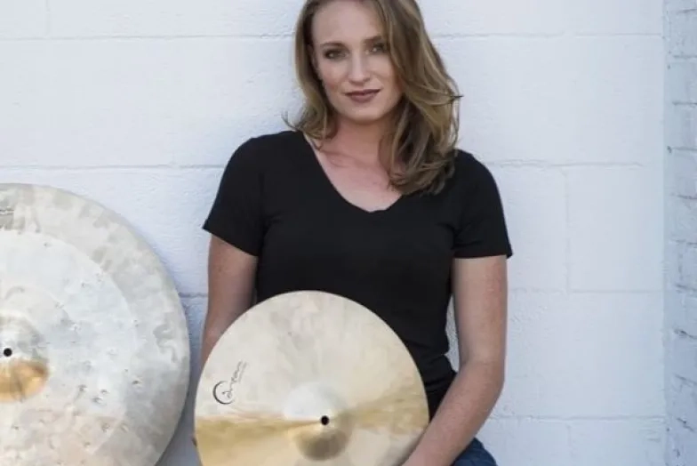 Kristen Klehr headshot while holding cymbal