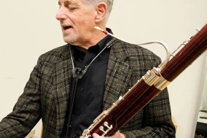 Stephen Paulson headshot while holding bassoon