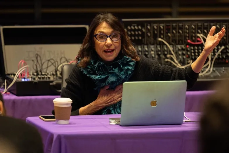 Suzanne Ciani at a table gesturing