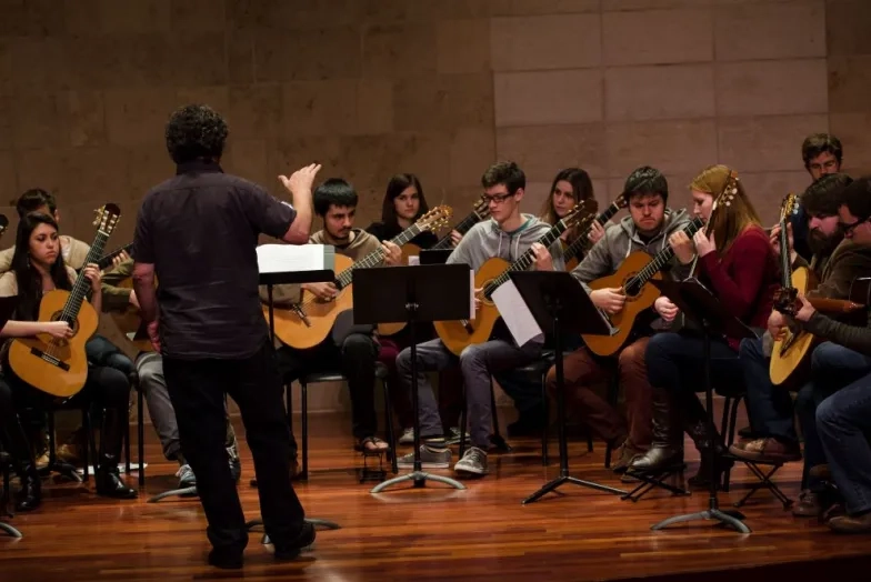 David Tanenbaum conducts an ensemble of guitar students