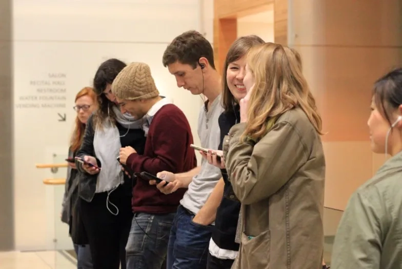 a line of students listening to music through headphones