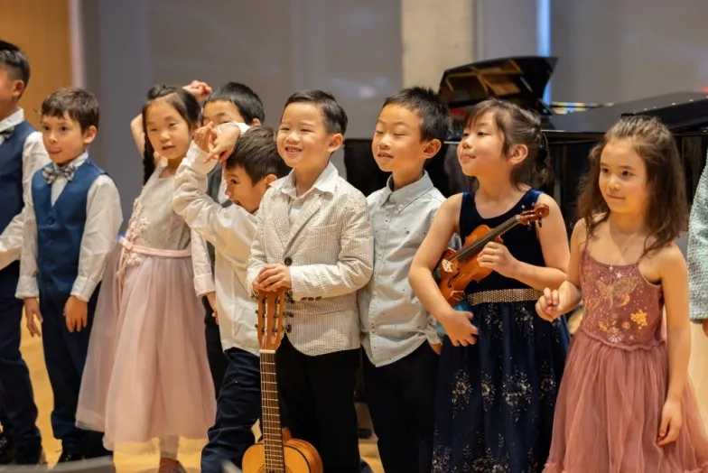pre-college students lines up for bows after a recital