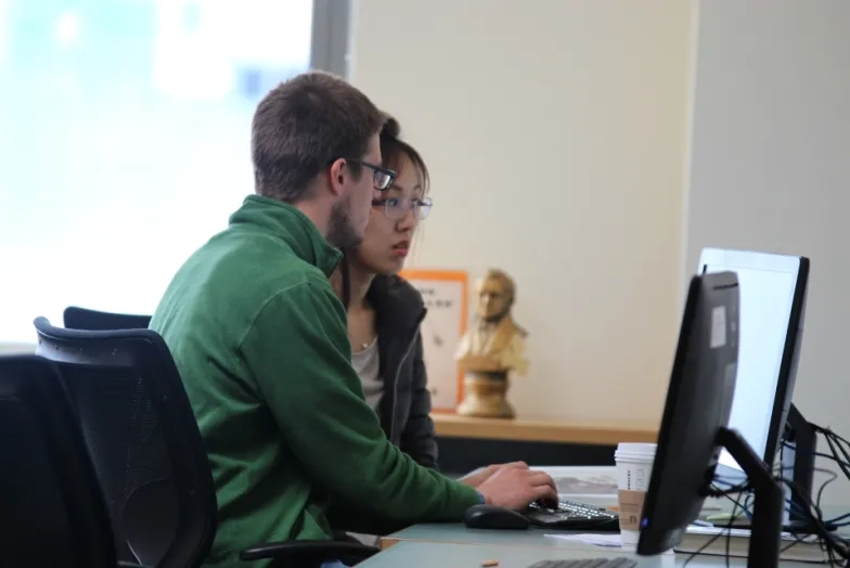 students sit at a computer