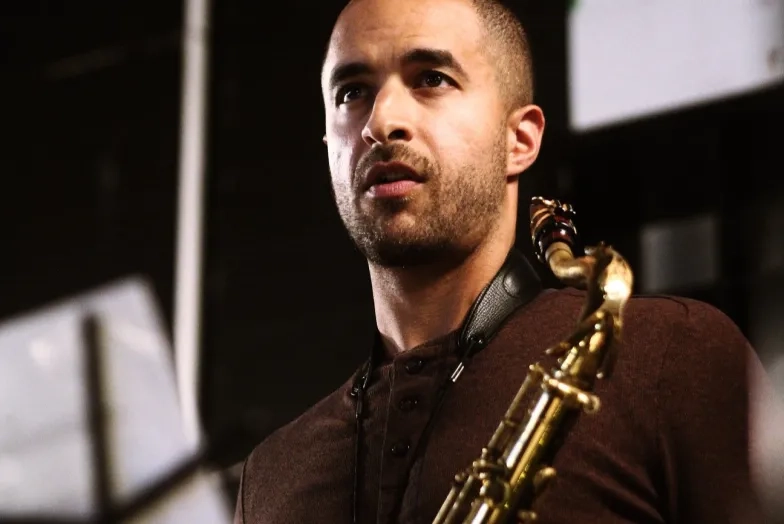 Tony peebles with his saxophone in front of a music stand
