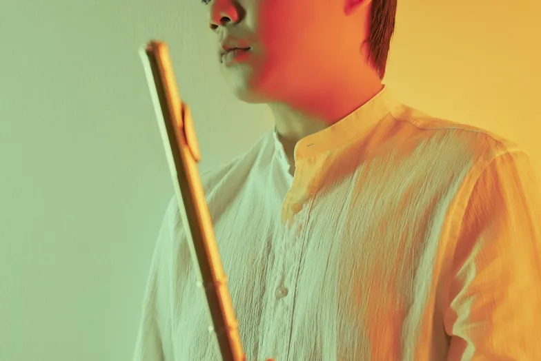 Yubeen Kim Yubeen Kim holding a flute
