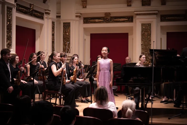 Pre-College student Arianna Lu playing piano for string orchestra