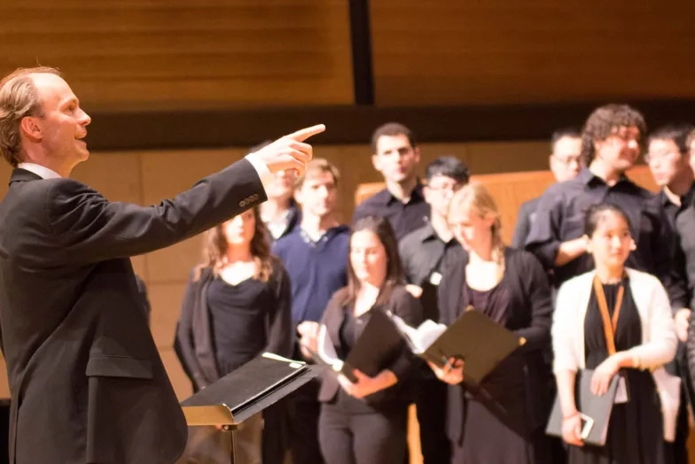 A choir director and a chorus A choir director and a chorus