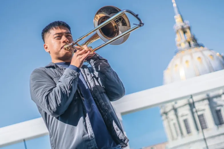 SFCM student playing trombone in front of City Hall