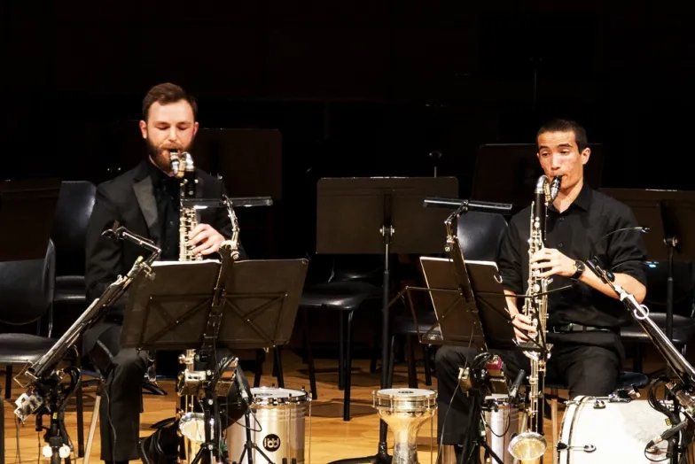 4 clarinet players playing together in a concert