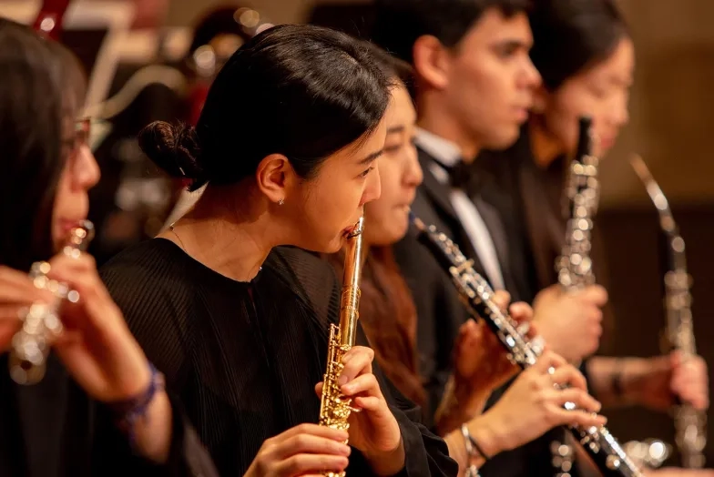 A SFCM student performing on the flute in the SFCM orchestra A SFCM student performing on the flute in the SFCM orchestra