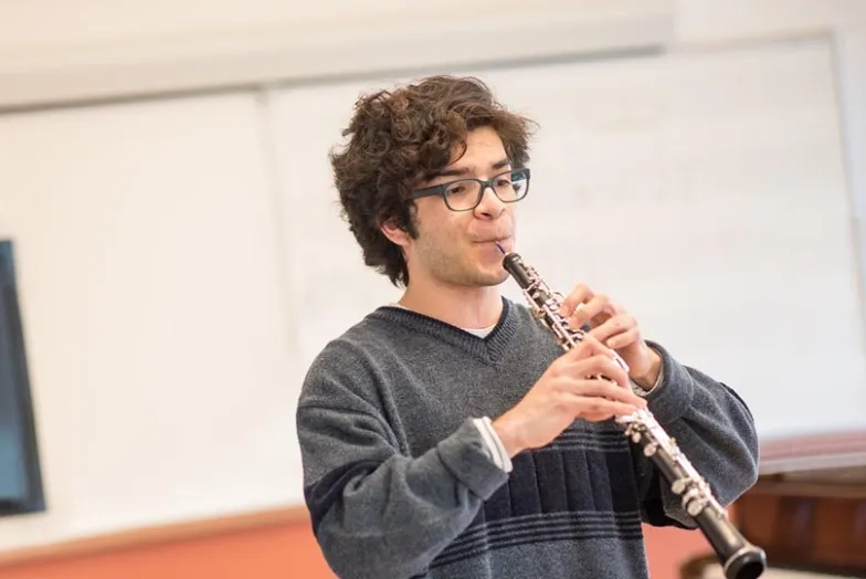 A photo of a student playing oboe