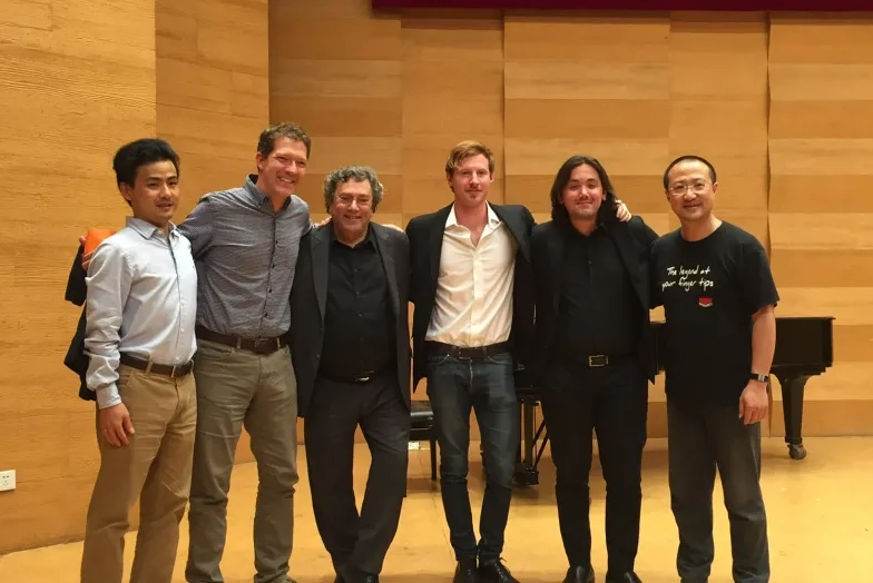 Students and faculty in a recital hall