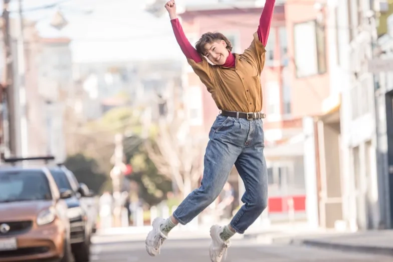 Student jumping up in excitement while outside