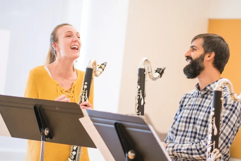 Jeff Anderle teaches a student, theyre both holding bass clarinets