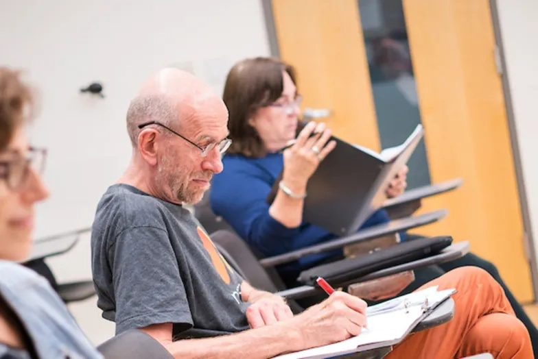Continuing education students sit at desks in a class