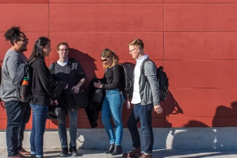 SFCM students in front of a red wall