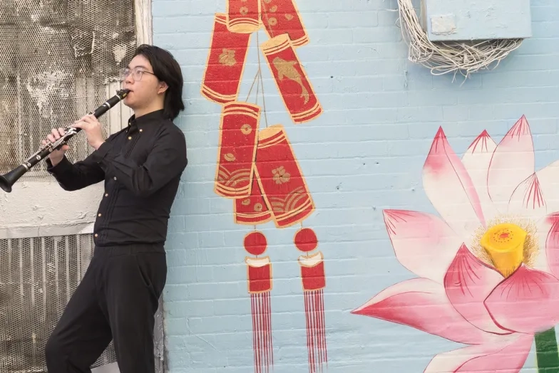 Student Outside playing clarinet