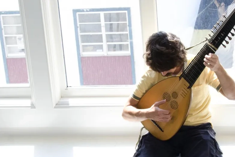 picture of a historical lute being played by a student
