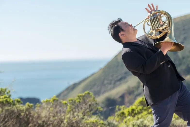 SFCM horn student outside in nature