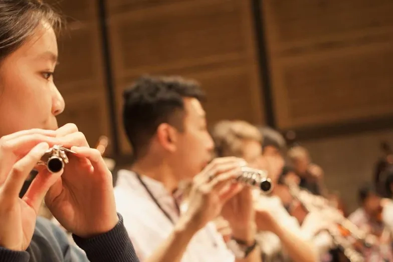 wind players during orchestra rehearsal
