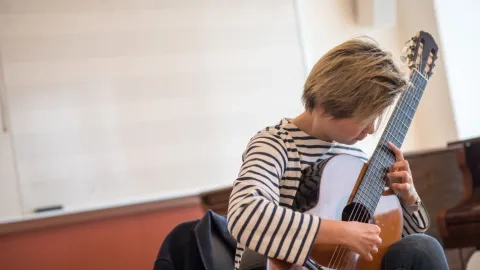 Meng Su Playing Guitar