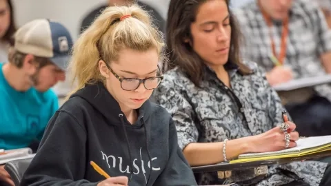a student sits at a desk